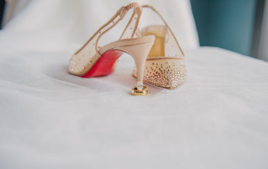 a gorgeous pair of hi-heeled shoes with a wedding ring