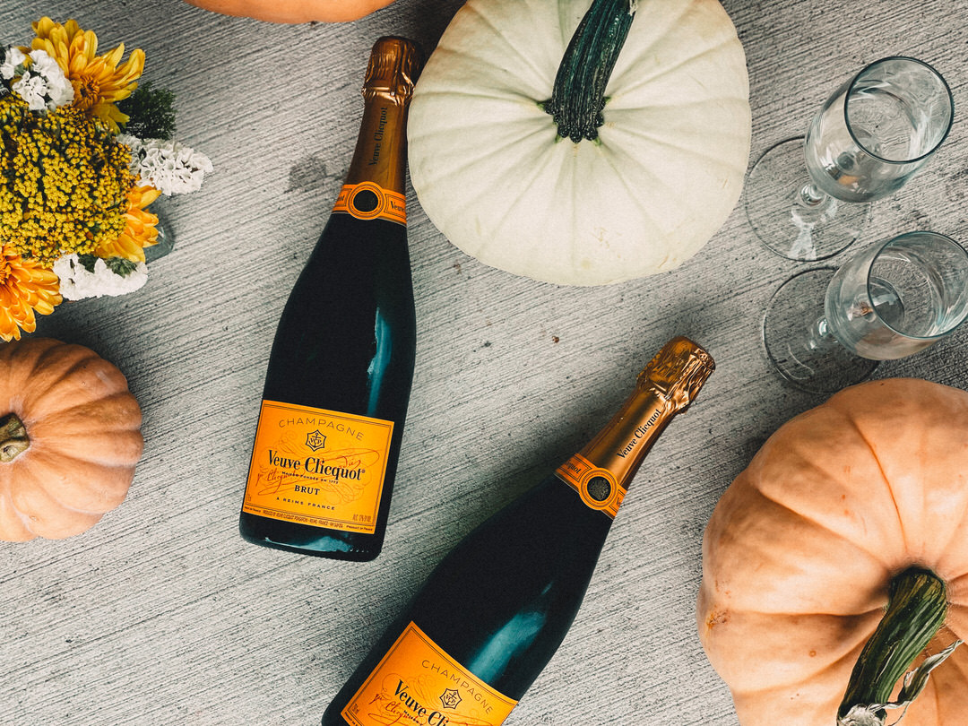 Veuve Clicquot Thanksgiving wine bottle on elegant fall wedding table setting.