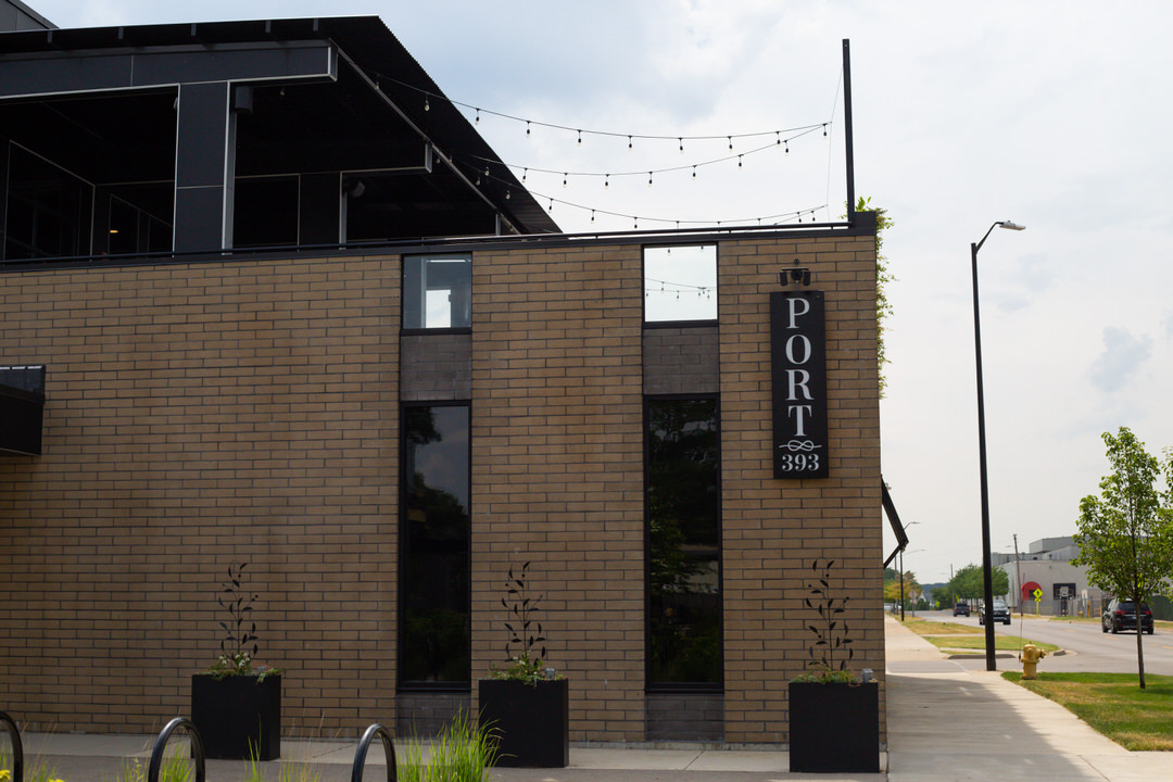 Port 393 building with sign, offering outdoor and indoor wedding ceremonies with creative options.
