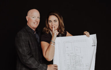 Candice and Brian Grant holding the plans for their new building, The Cove